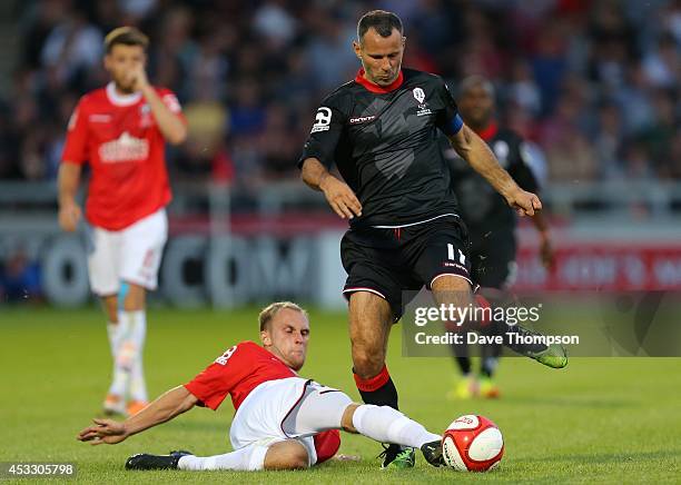 Ryan Giggs of the Class of '92 XI gets away from Nicky Platt of Salford City during the match between Salford City and the Class of '92 XI at AJ Bell...