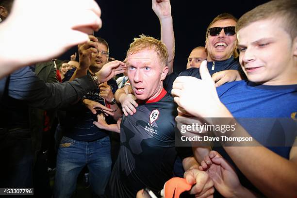 Paul Scholes of the Class of '92 XI is mobbed by fans at the end of the match between Salford City and the Class of '92 XI at AJ Bell Stadium on...