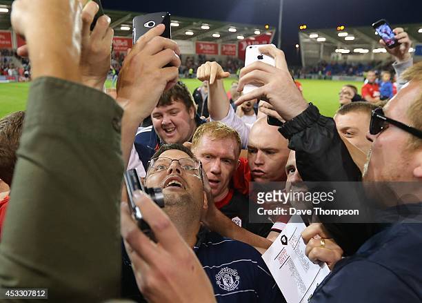 Paul Scholes of the Class of '92 XI is mobbed by fans at the end of the match between Salford City and the Class of '92 XI at AJ Bell Stadium on...