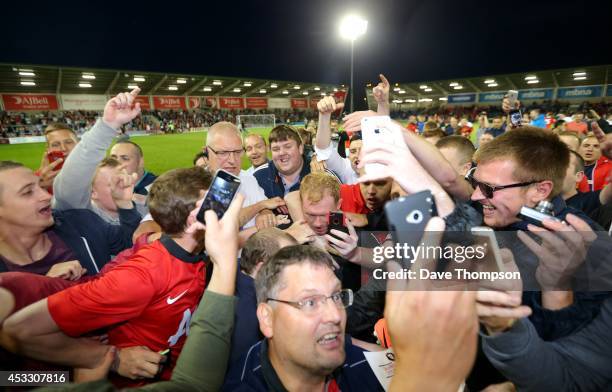 Paul Scholes of the Class of '92 XI is mobbed by fans at the end of the match between Salford City and the Class of '92 XI at AJ Bell Stadium on...