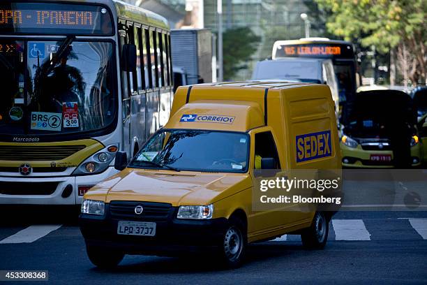 Postal worker drives a vehicle in Rio de Janeiro, Brazil, on Thursday, Aug. 7, 2014. Brazilian postal workers became unlikely victims of Argentina's...