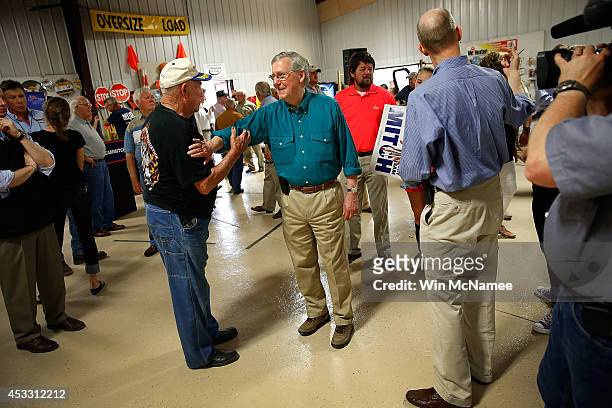 Senate Minority Leader Mitch McConnell greets supporters after he spoke while campaigning at a Rental Pro store during a two day bus tour of eastern...