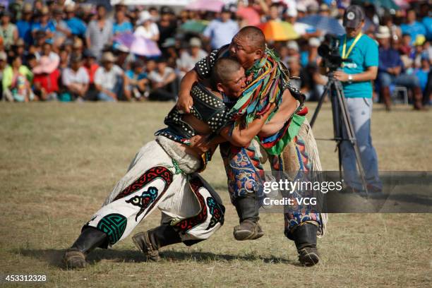 Wrestlers compete during the annual Naadam festival on July 29, 2014 in Xilinhot, Inner Mongolia Autonomous Region of China. Around 768 people...