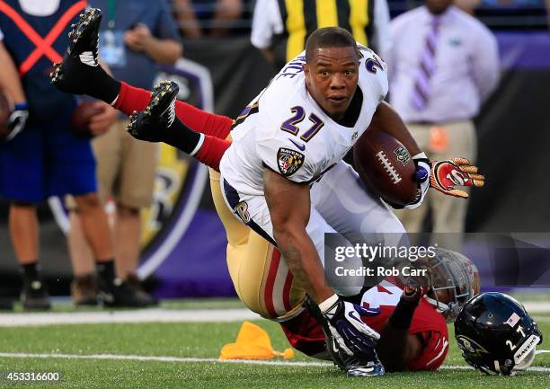 Running back Ray Rice of the Baltimore Ravens looses his helmet after being tackled by strong safety Antoine Bethea of the San Francisco 49ers during...