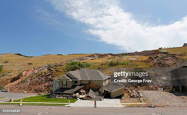 House is shown destroyed by a landslide that broke loose earier this week on August 7, 2014 in North Salt Lake City, Utah. The family fled moments...