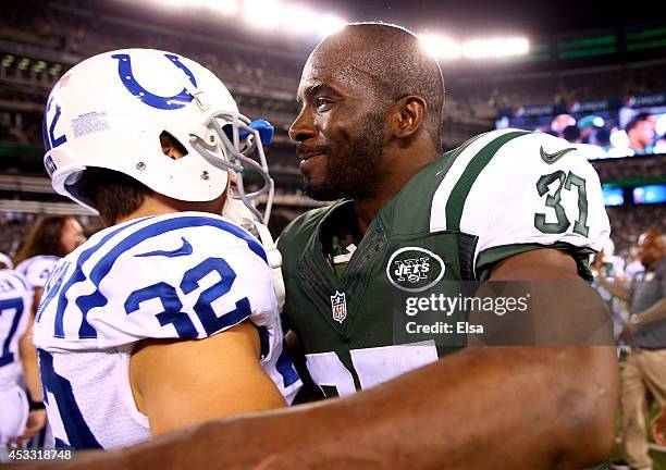 Free safety Jaiquawn Jarrett of the New York Jets meets free safety Colt Anderson of the Indianapolis Colts on the field following a preseason game...