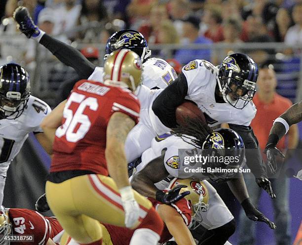 The Baltimore Ravens' Asa Jackson leaps over the San Francisco 49ers defense in the second quarter during preseason action at M & T Bank Stadium in...