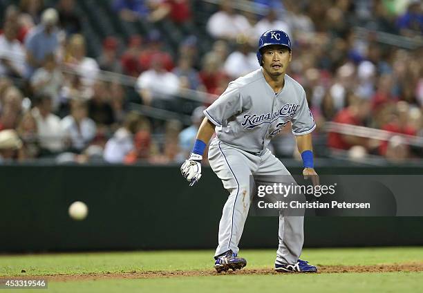 Norichika Aoki of the Kansas City Royals leads off of third base as the ball is hit in play during the MLB game against the Arizona Diamondbacks at...