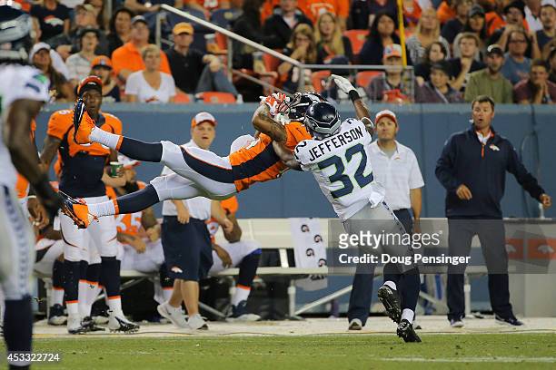 Wide receiver Cody Latimer of the Denver Broncos goes up for an attempted catch under coverage by cornerback A.J. Jefferson of the Seattle Seahawks...