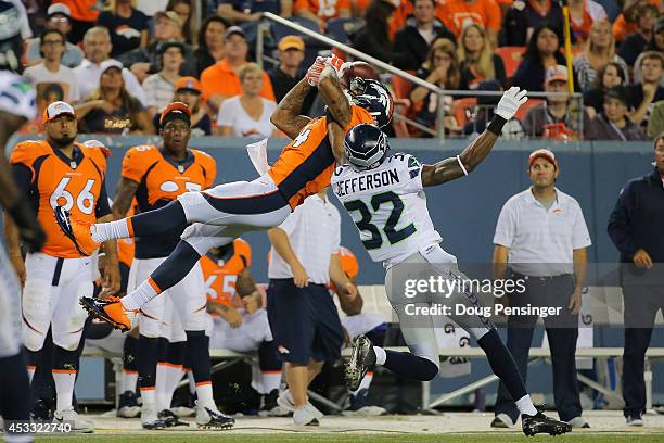 Wide receiver Cody Latimer of the Denver Broncos goes up for an attempted catch under coverage by cornerback A.J. Jefferson of the Seattle Seahawks...