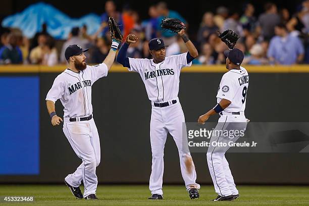Outfielders Dustin Ackley , Austin Jackson, and Endy Chavez of the Seattle Mariners celebrate after defeating the Chicago White Sox 13-3 at Safeco...