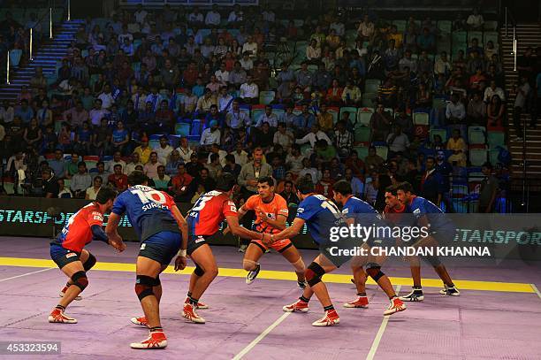 To go with India-Sport-Lifestyle-Kabaddi by Abhaya Srivastava In this photograph taken on August 6 a raider of Bengal Warriors attempts to tag one of...