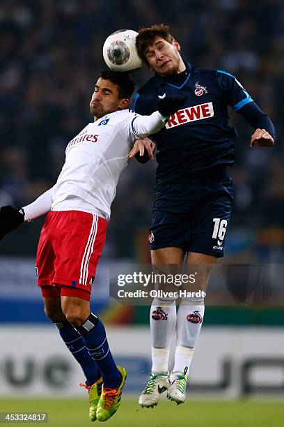 Tomas Rincon of Hamburg and Patrick Helmes of Koeln compete for the ball during the DFP Cup round of 16 at Imtech Arena on December 3, 2013 in...