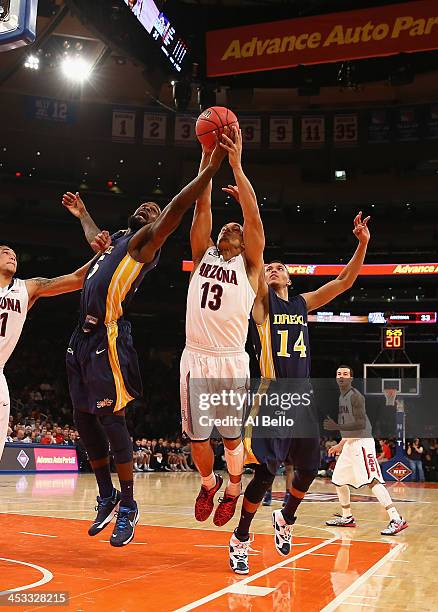 Nick Johnson of the Arizona Wildcats battles for the ball against Stevan Manojlovic and Damion Lee of the Drexel Dragons during their Semi Final game...