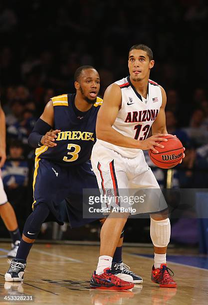 Nick Johnson of the Arizona Wildcats in action against Chris Fouch of the Drexel Dragons during their Semi Final game of the NIT Season Tip Off at...