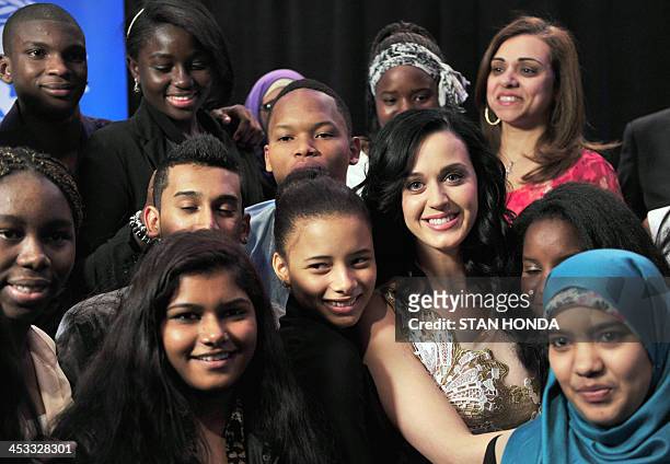 Singer Katy Perry poses with local students after being named a UNICEF goodwill ambassador December 3, 2013 at UNICEF headquarters in New York. AFP...