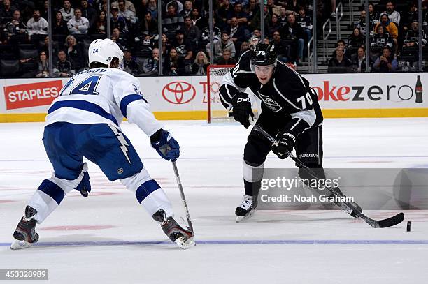 Tanner Pearson of the Los Angeles Kings skates with the puck against Dmitry Korobov of the Tampa Bay Lightning at Staples Center on November 19, 2013...