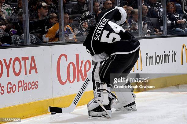 Ben Scrivens of the Los Angeles Kings plays the puck against the Tampa Bay Lightning at Staples Center on November 19, 2013 in Los Angeles,...