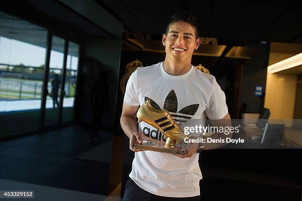 Footballer James Rodriguez receives his adidas Golden Boot Trophy at Real Madrid's Valdebebas in recognition of scoring the most goals during the...