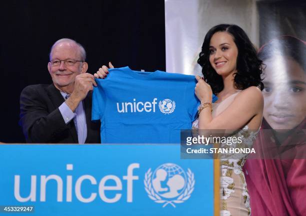 Singer Katy Perry is presented a t-shirt by UNICEF Executive Director Anthony Lake at an event where she was named a UNICEF goodwill ambassador...