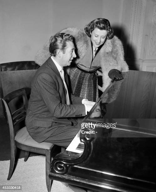 Picture taken on March 6, 1952 shows French singers Yvette Giraud with Charles Trenet at the piano during a reception given by the company...