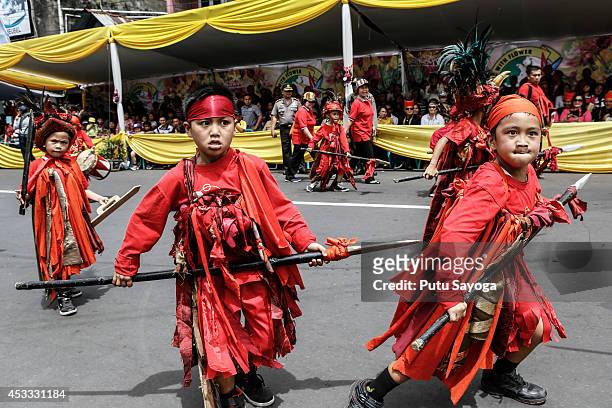 Participants dance during Tomohon International Flower Festival on August 8, 2014 in Tomohon, North Sulawesi, Indonesia. The flower festival is a...