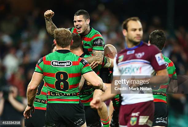 Adam Reynolds and other Rabbitohs team mates celebrate a try by Sam Burgess during the round 22 AFL match between the South Sydney Rabbitohs and the...