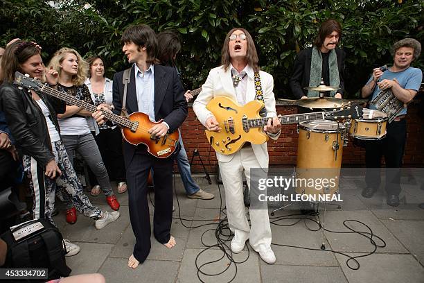 The cast of the musical "Let It Be" perform near famous Abbey Road zebra crossing in London, England on August 8 the 45th anniversary of the day that...