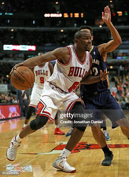 Mike James of the Chicago Bulls moves past Brian Roberts of the New Orleans Pelicans at the United Center on December 2, 2013 in Chicago, Illinois....