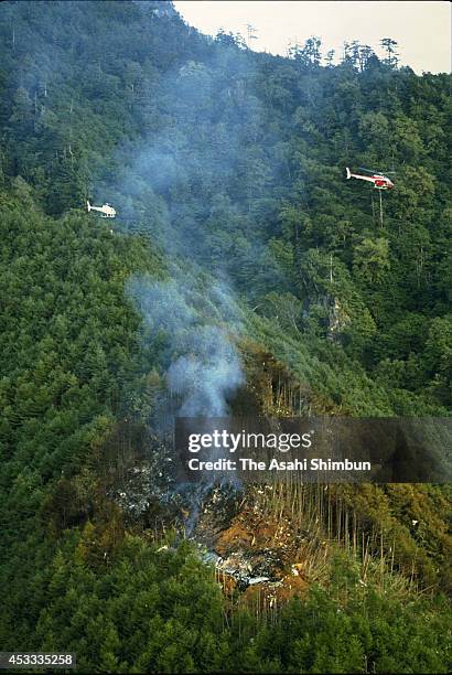 Smoke rises from the crash site at the ridge of Mount Osutaka a day after the air crash on August 13, 1985 in Ueno, Gunma, Japan. Japan Airlines...