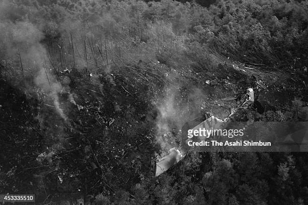 In this aerial image, smoke rises from a primary wing of the JAL 123 at the ridge of Mount Osutaka on August 13, 1985 in Ueno, Gunma, Japan. Japan...