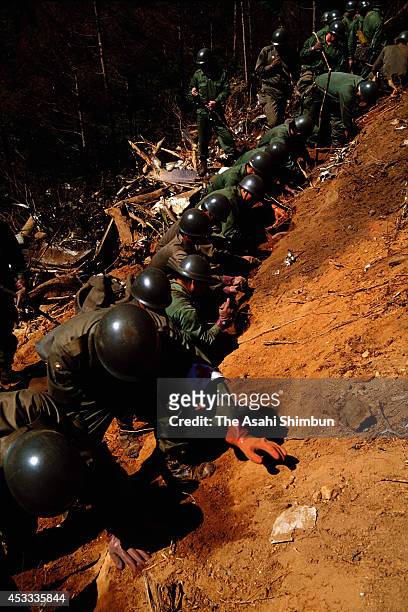 Members of the Japan Ground Self-Defense Force in a rescue operation at the crash site at the ridge of Mount Osutaka on August 15, 1985 in Ueno,...