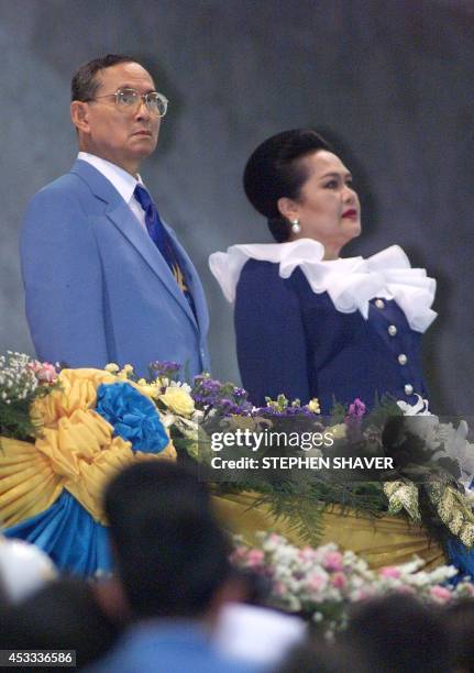 Thai King Bhumibol Adulyadej and Queen Sirikit listen to the Thai royal anthem while entering Bangkok's Rajamangala National Stadium 06 December...