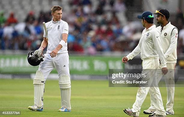 England batsman Joe Root has a chat with India fielder Virat Kohli as they leave the field due to rain during day two of the 4th Investec Test match...