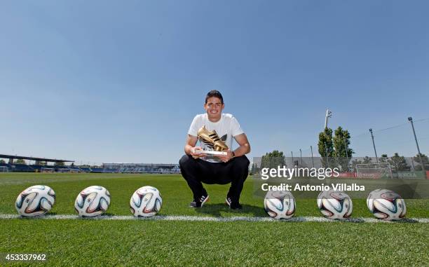 Footballer James Rodriguez receives his adidas Golden Boot Trophy at Real Madrid's Valdebebas in recognition of scoring the most goals during the...