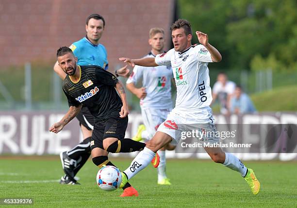 Benjamin Köhler passes the ball past Stefan Schwendinger during the test match between 1 FC Union Berlin and Wolfsberger AC on july 5, 2014 in...