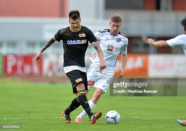 Christopher Trimmel passes the ball past Tadej Trdina during the test match between 1 FC Union Berlin and Wolfsberger AC on july 5, 2014 in...