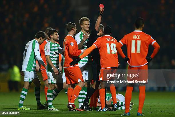 Ricardo Fuller of Blackpool is shown a red card by referee Christopher Sarginson after head butting Luke Ayling of Yeovil Town during the Sky Bet...