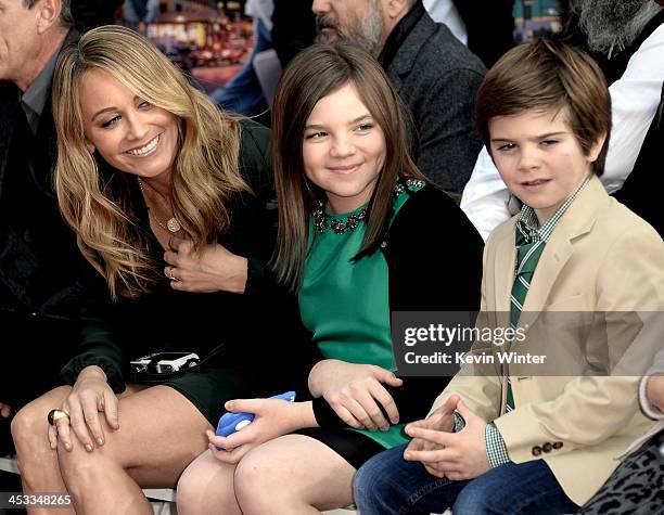 Actress Christine Taylor and her children Ella Stiller and Quinlin Stiller watch as actor Ben Stiller is honored with a hand and footprint ceremony...