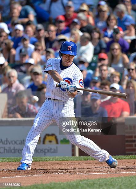 Tsuyoshi Wada of the Chicago Cubs puts the ball in play during the second inning against the Tampa Bay Rays at Wrigley Field on August 8, 2014 in...