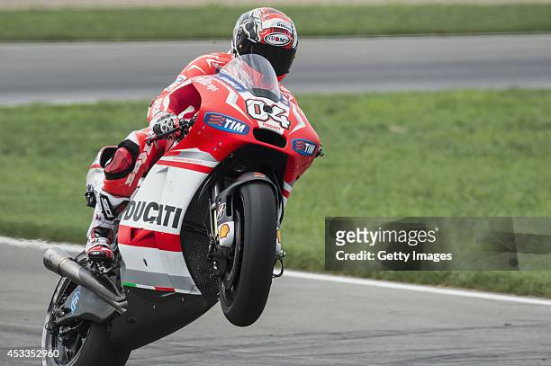 Andrea Dovizioso of Italy and Ducati Team lifts the front wheel during the MotoGp Red Bull U.S. Indianapolis Grand Prix - Free Practice at...