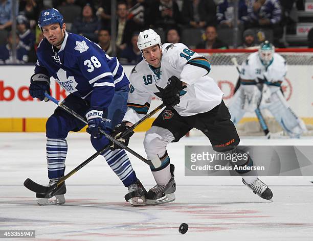 Mike Brown of the San Jose Sharks skates against Frazer McLaren of the Toronto Maple Leafs during an NHL game at the Air Canada Centre on December 3,...