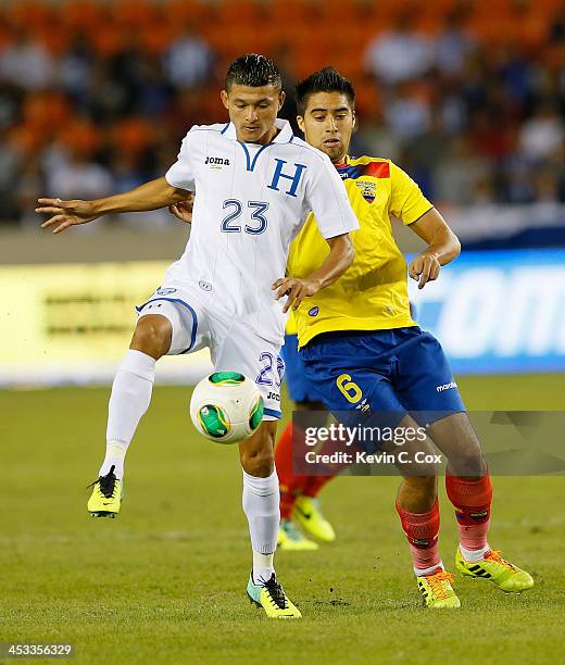 Edder Delgado of Honduras against Christian Noboa of Ecuador during an international friendly match at BBVA Compass Stadium on November 19, 2013 in...