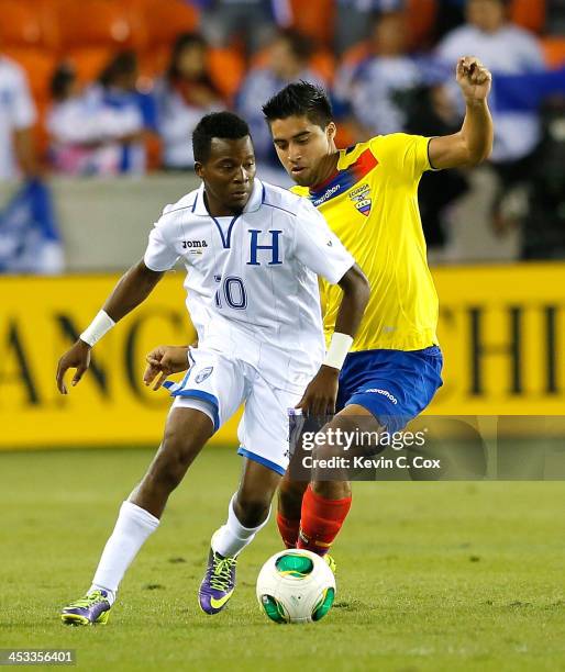 Marvin Chavez of Honduras against Christian Noboa of Ecuador during an international friendly match at BBVA Compass Stadium on November 19, 2013 in...