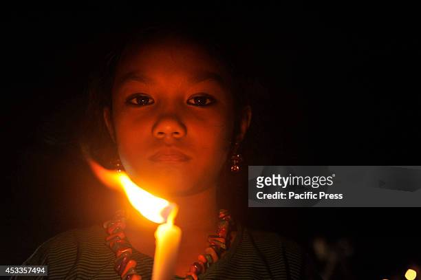 Indigenous people light candles at Central Shahid Minar in Dhaka, to celebrate the International Day of the World's Indigenous People 2014. The...