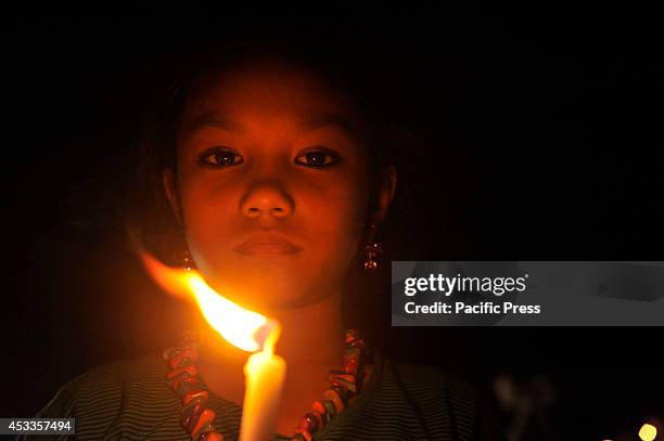 Indigenous people light candles at Central Shahid Minar in Dhaka, to celebrate the International Day of the World's Indigenous People 2014. The...