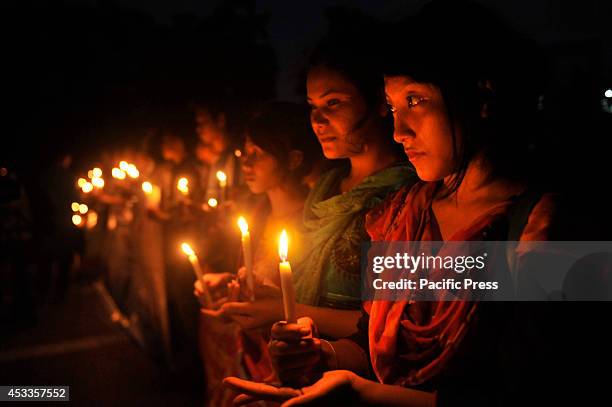 Indigenous people light candles at Central Shahid Minar in Dhaka, to celebrate the International Day of the World's Indigenous People 2014. The...