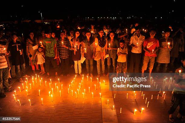 Indigenous people light candles at Central Shahid Minar in Dhaka, to celebrate the International Day of the World's Indigenous People 2014. The...