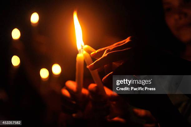 Indigenous people light candles at Central Shahid Minar in Dhaka, to celebrate the International Day of the World's Indigenous People 2014. The...