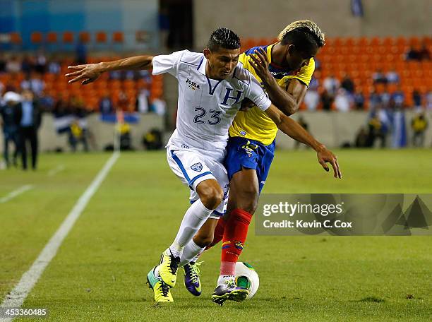 Edder Delgado of Honduras against Fidel Martínez of Ecaudor during an international friendly match at BBVA Compass Stadium on November 19, 2013 in...